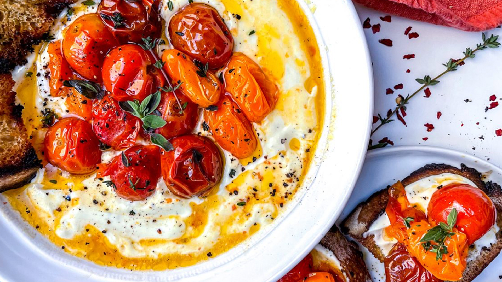 Whipped feta dip with roasted garlic, tomatoes and olives