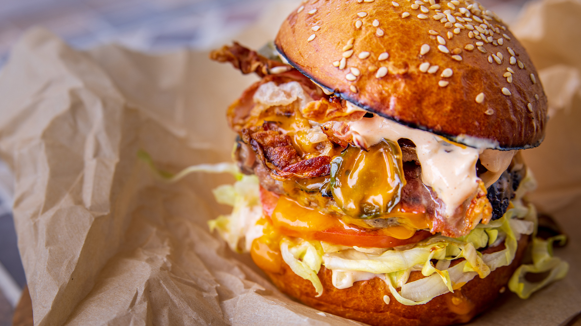 A very Canadian burger with melted leeks, cheddar and bacon