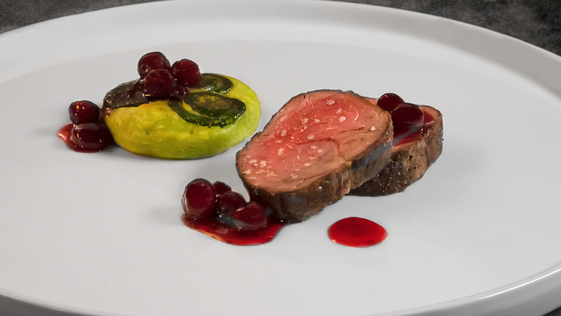 Venison loin with cranberry and fiddlehead