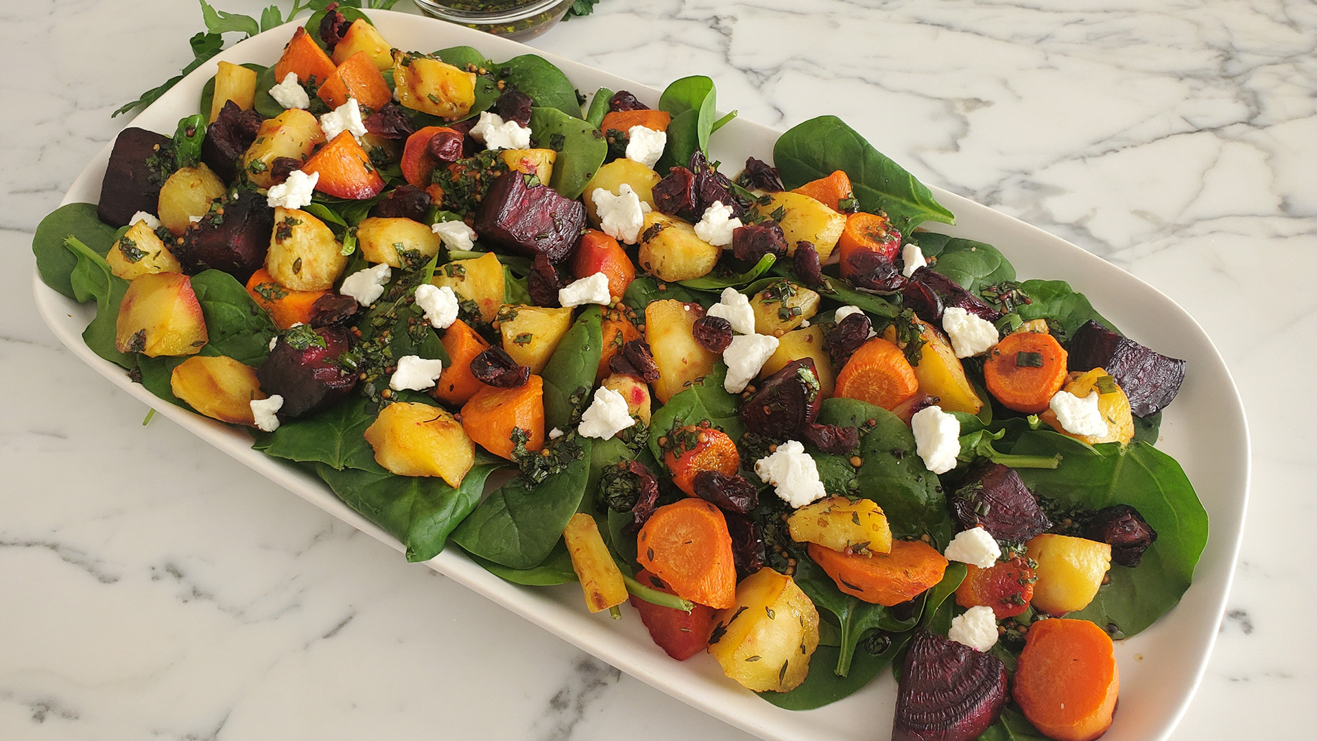 Garlic roasted root vegetable salad with cranberry and goat cheese