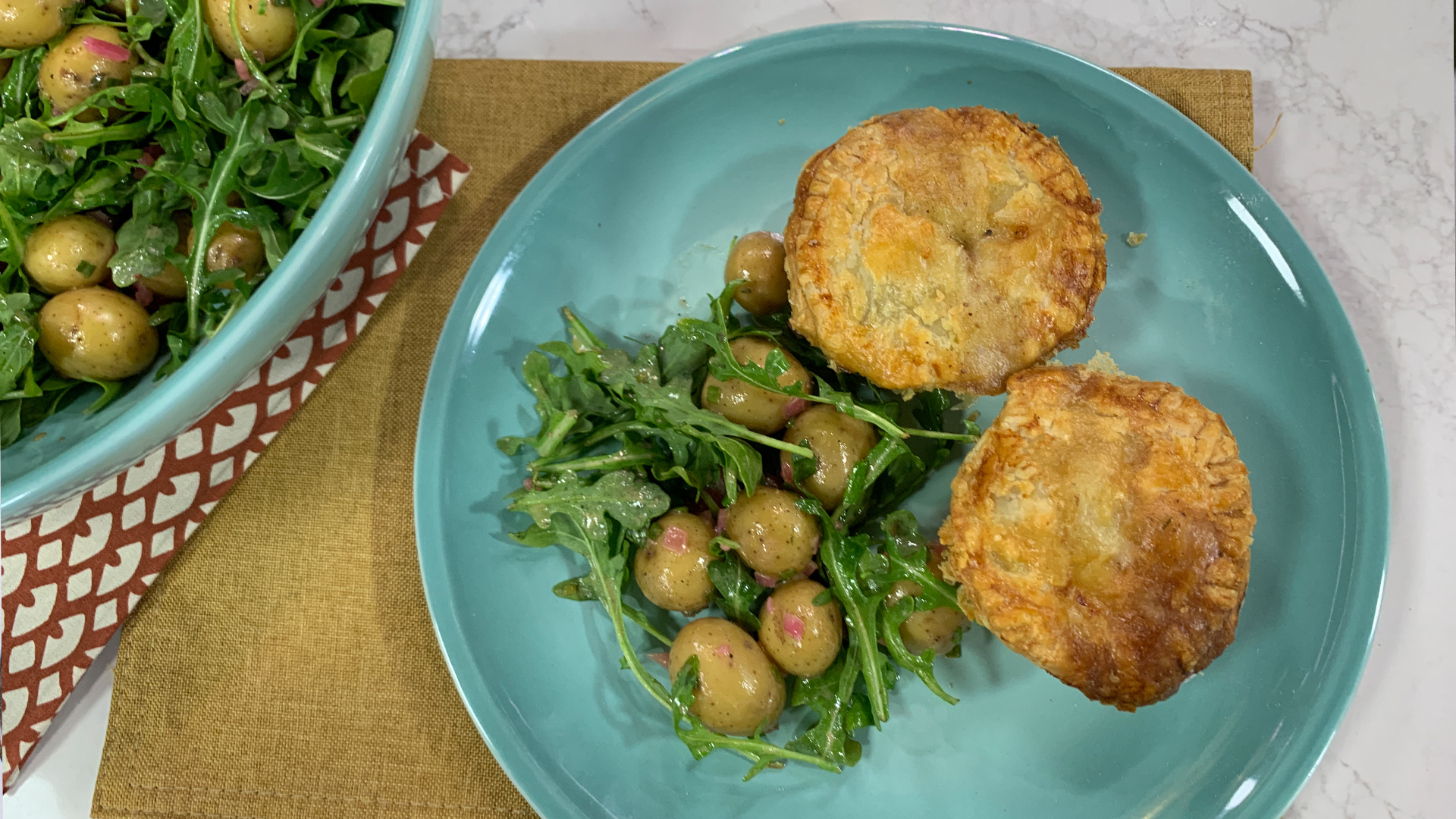 Lamb and cheddar pies and potato salad with arugula and Dijon