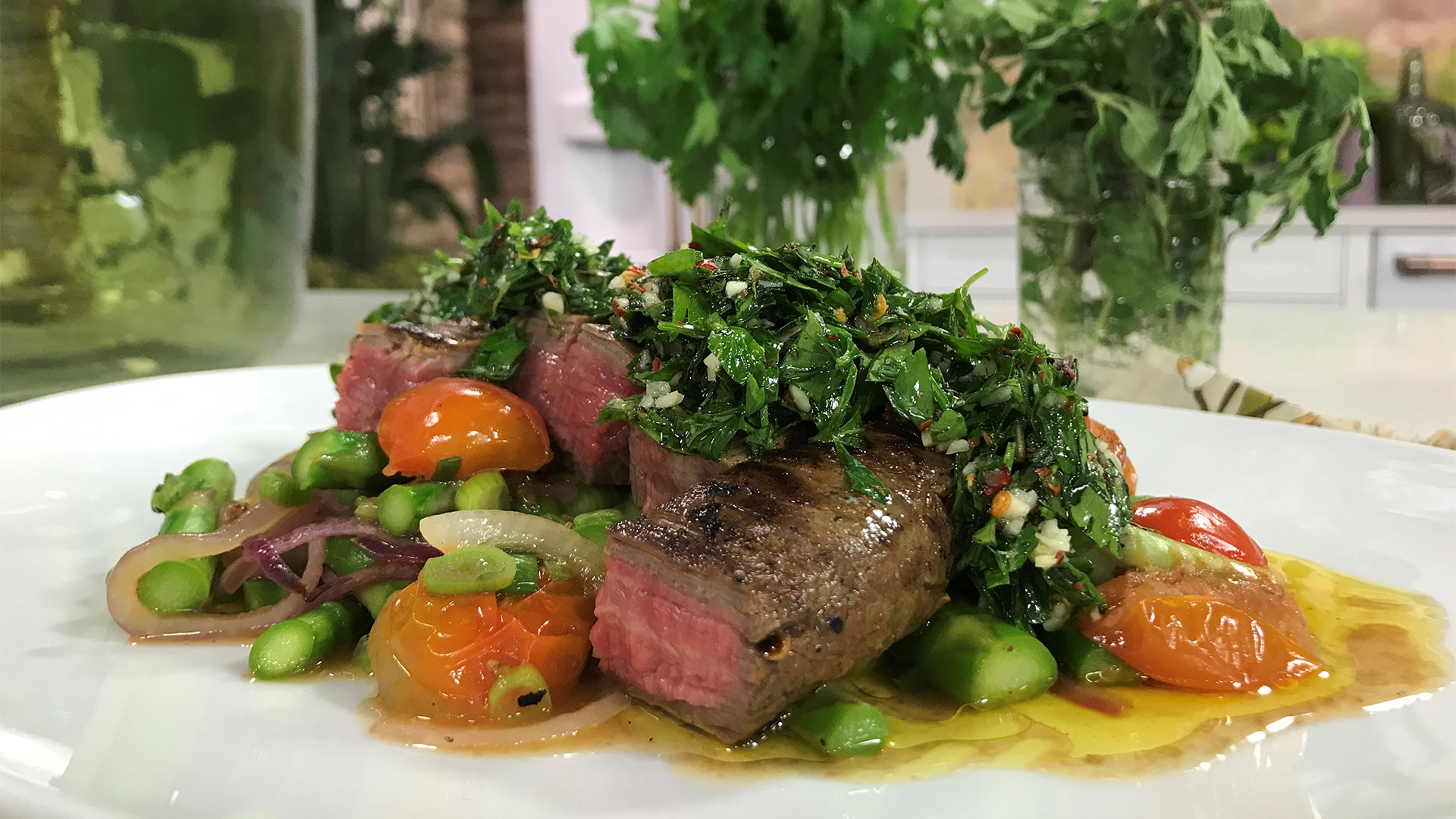 Grilled steak and vegetables with herby chimichurri sauce
