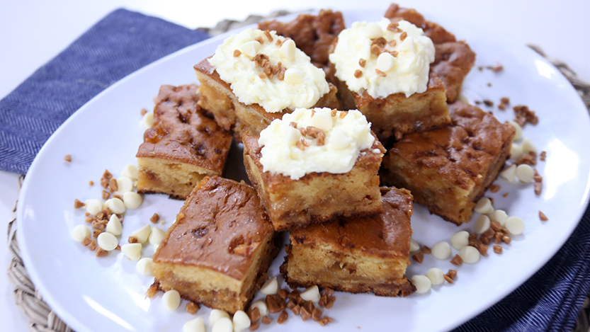 White chocolate toffee blondies with whipped cream frosting
