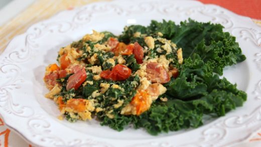 Scrambled eggs with sautéed kale, garlic and cherry tomatoes