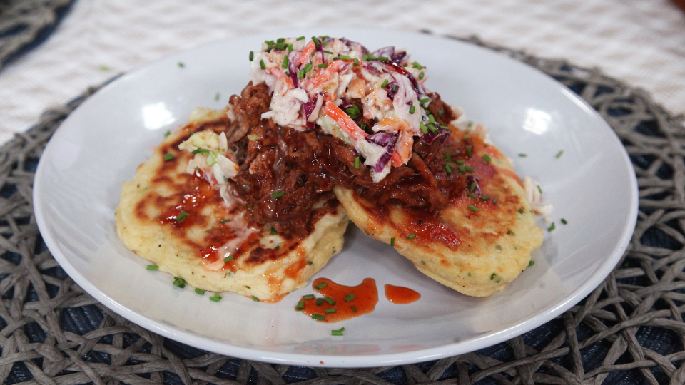 Cheddar-chive pancakes with BBQ pulled pork, coleslaw and sweet Sriracha drizzle