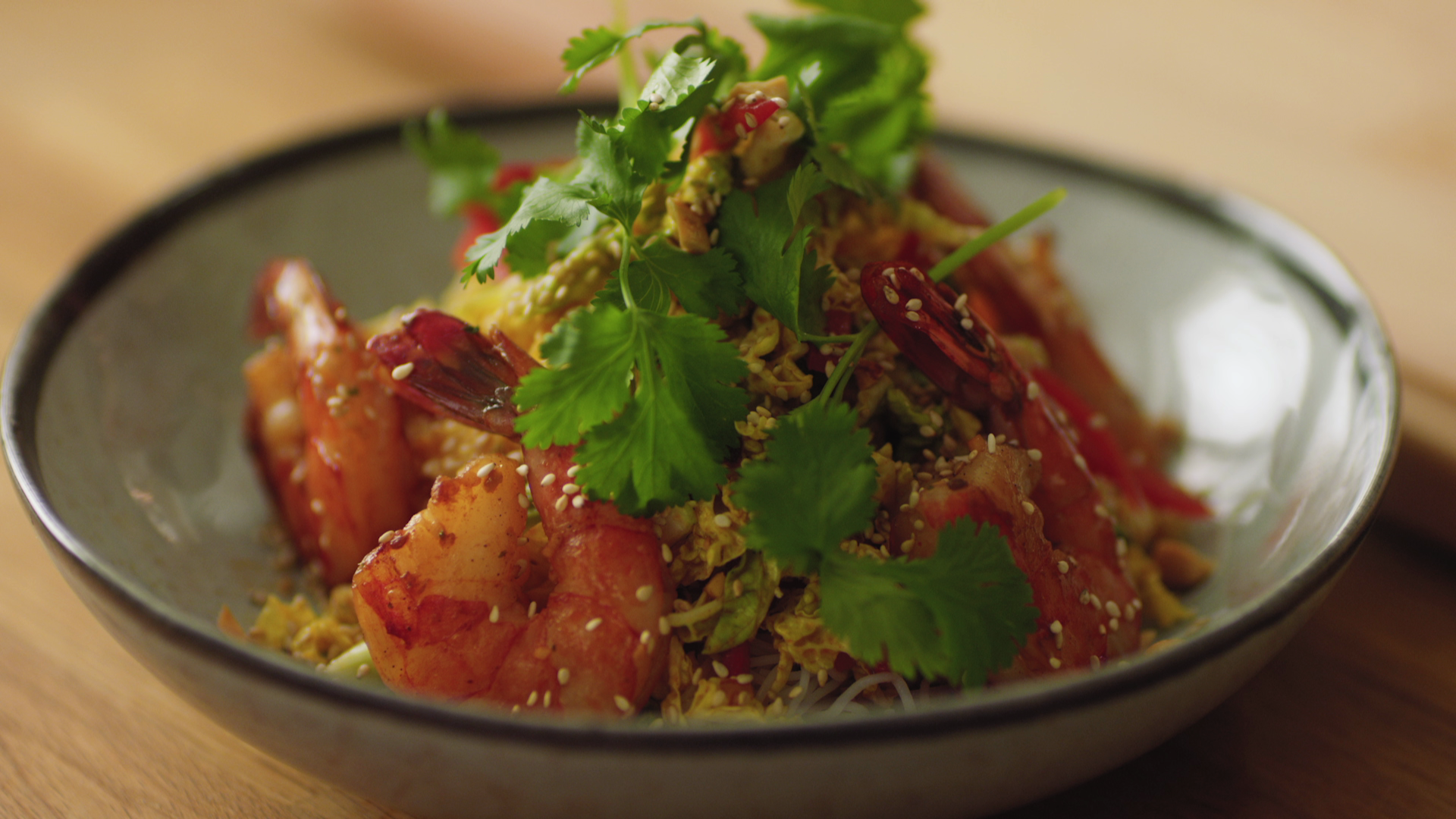 Grilled shrimp skewers over Asian noodle salad
