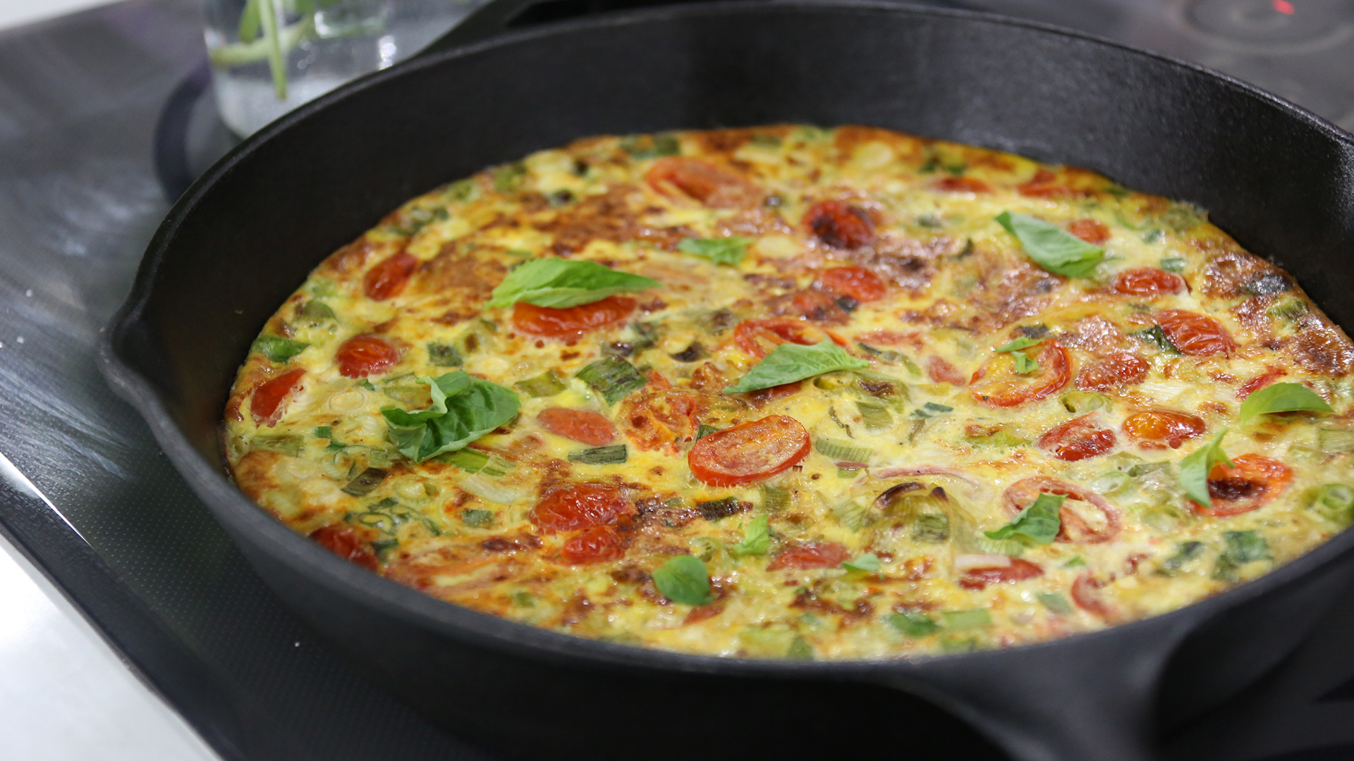 Summer frittata with tomato, basil, leeks and green onions