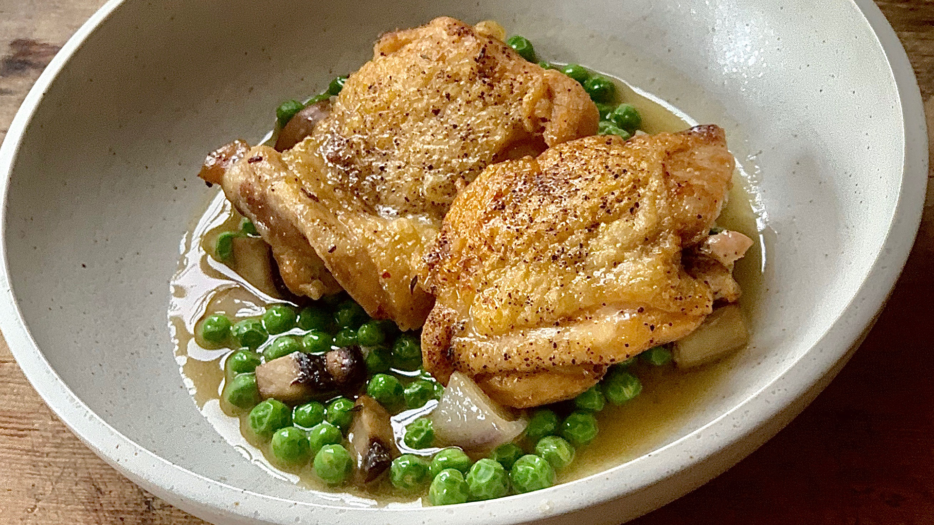 Braised chicken with spring peas and onions