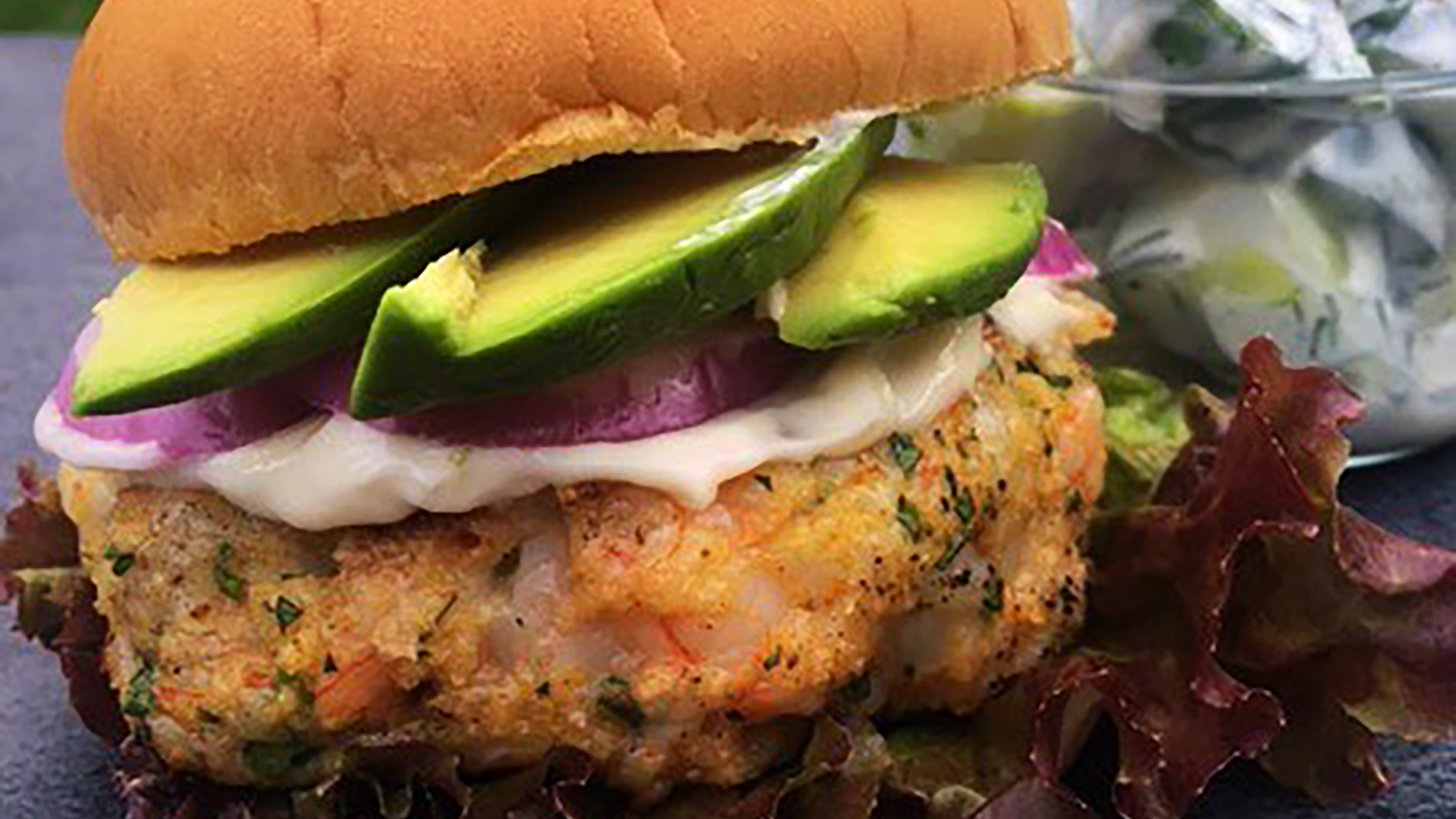 Chili shrimp burgers with grilled onion and avocado mayo